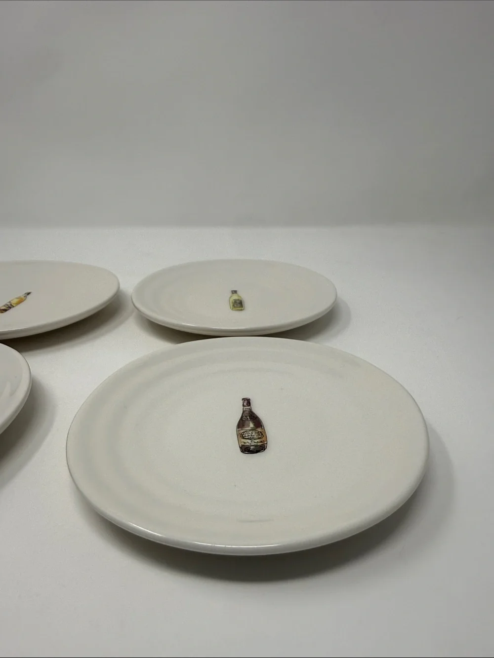 Williams Sonoma Cream Ceramic Dinner Plates with Wine Bottle Motifs - Set of 4